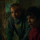 Two Choose or Die characters stare at a green, glowing computer screen with shocked looks on their faces.